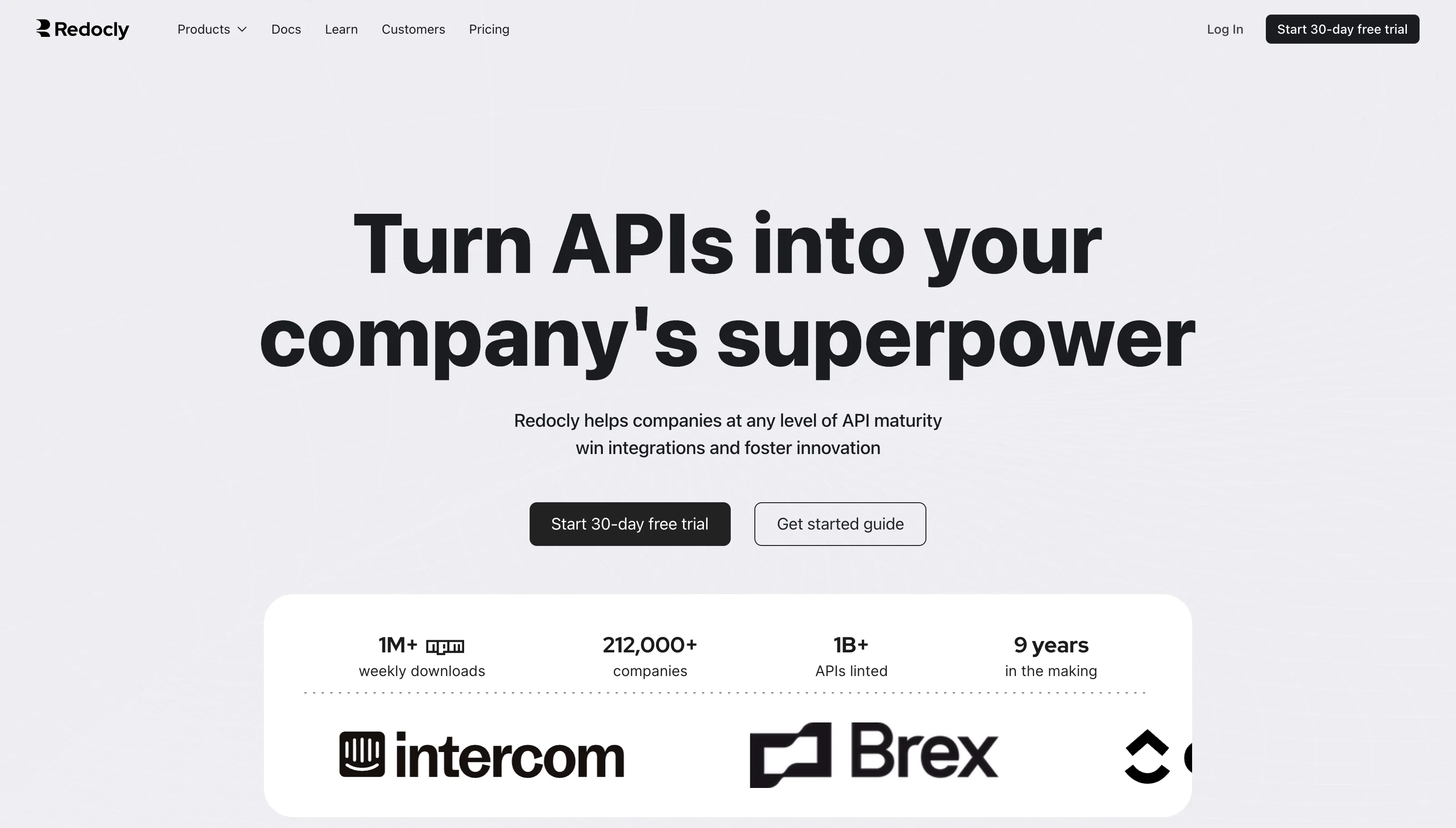 Redocly homepage headline "Turn APIs into your company's superpower" and a stats row reading 1M+ npm weekly downloads, 212,000+ companies, 1B+ APIs linted and 9 years in the making